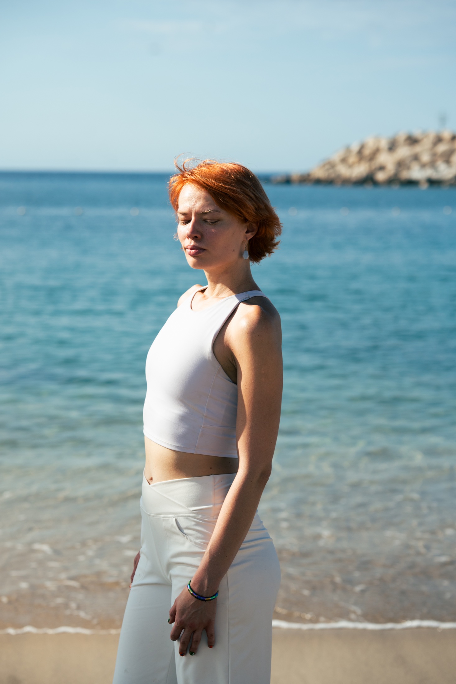Eugenia standing by the sea
